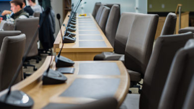 microphones chairs and tables in a council chamber