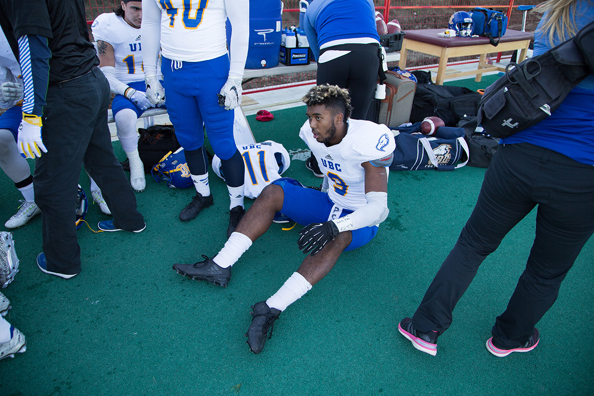 UBC's Malcom Lee receiving trainers attention on the sidelines.