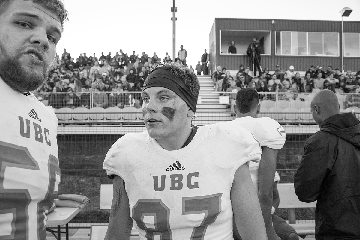 UBC's 6'7", 315lb lineman Alec Pennell (left) and tight end Liam Haime (right) talk on the sideline.