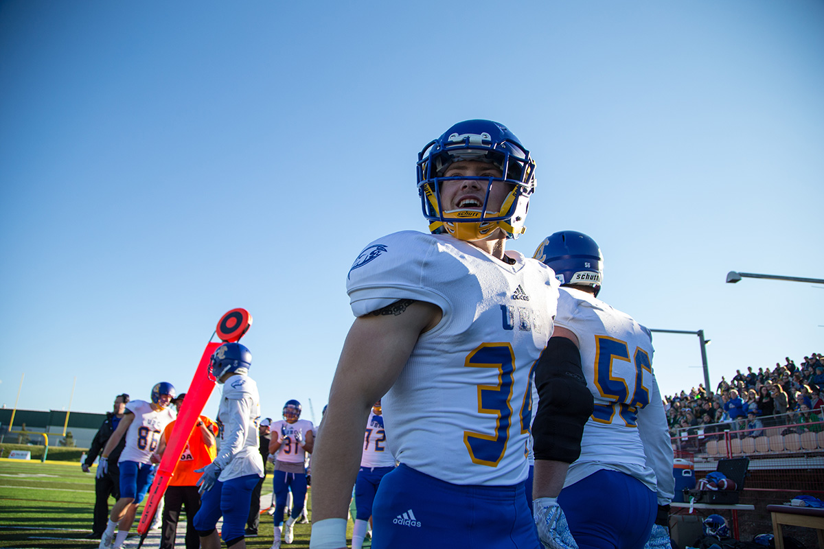 UBC running back Dwayne Neustaeter enjoys the show from sidelines. 