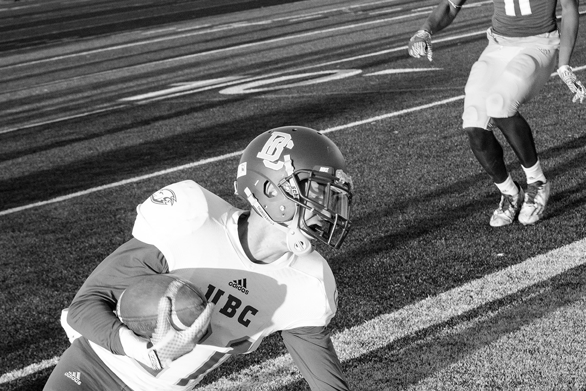 Trey Kellogg of UBC slides in for the score. 