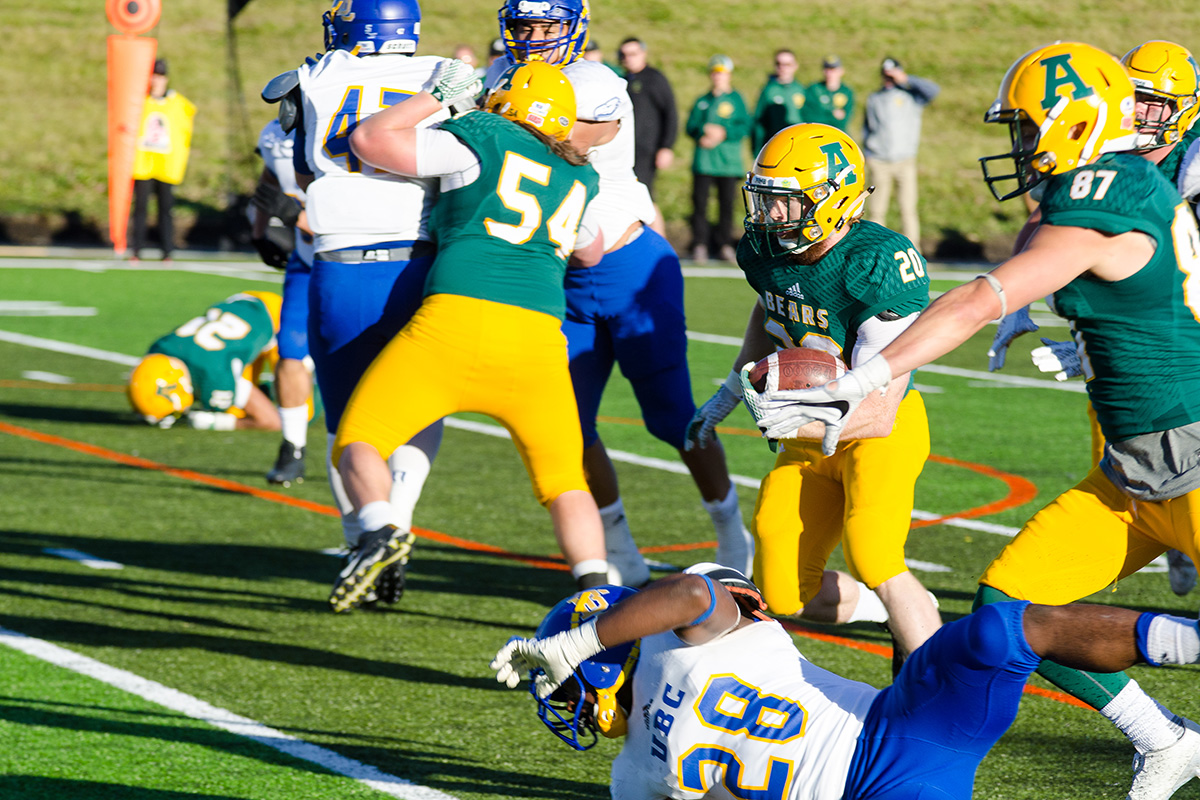 Second-year running back Alex Bradley marches through a mass of bodies.