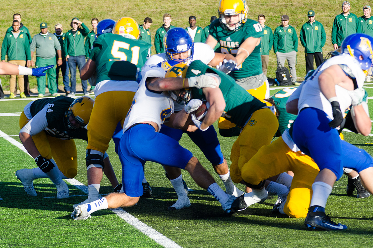 Fourth-year Bears running back Ed Ilnicki crashes into the Thunderbird line.