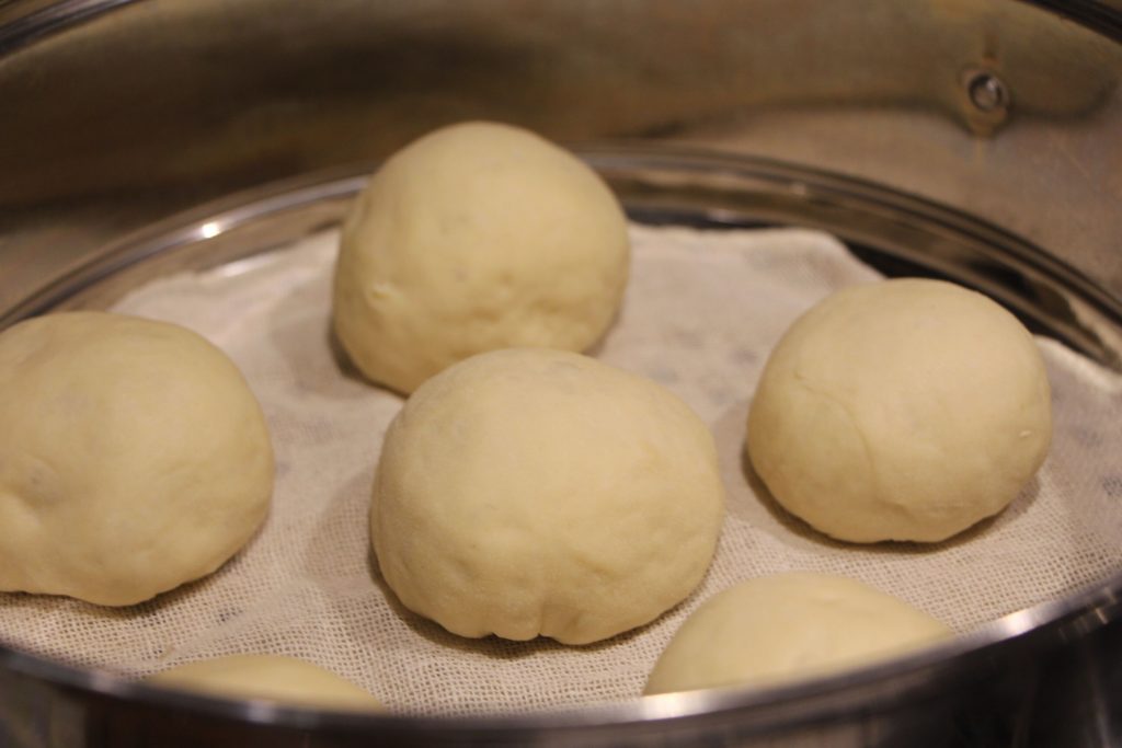 the uncooked buns resting in the pot