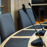 microphones and chairs in a council chamber