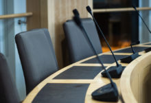 microphones and chairs in a council chamber