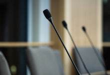 close up of microphones in a council chamber candidates