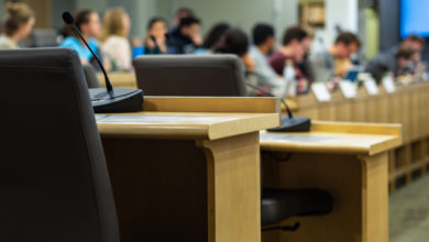 microphones and chairs in a council chamber