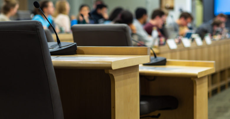 microphones and chairs in a council chamber