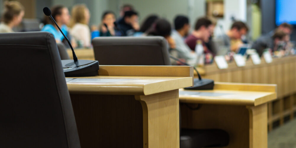 microphones and chairs in a council chamber