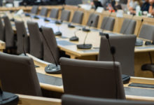 microphones and chairs in a council chamber