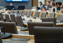 microphones and chairs in a council chamber