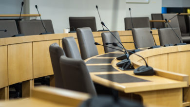microphones and chairs in a council chamber
