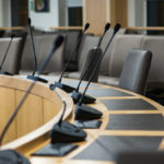 microphones and chairs in a council chamber