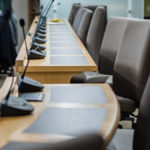 microphones chairs and tables in a council chamber