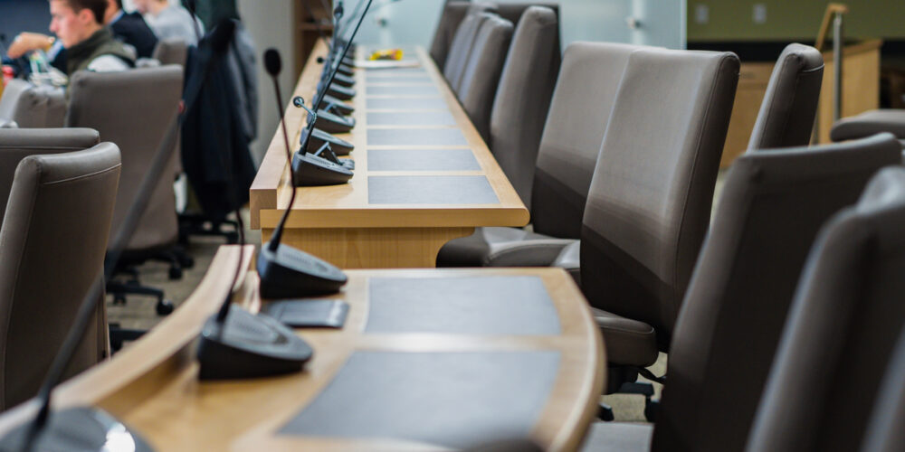 microphones chairs and tables in a council chamber