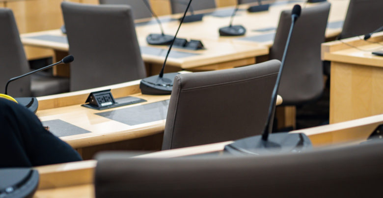 microphones and chairs in a council chamber