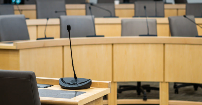 microphones and chairs in a council chamber