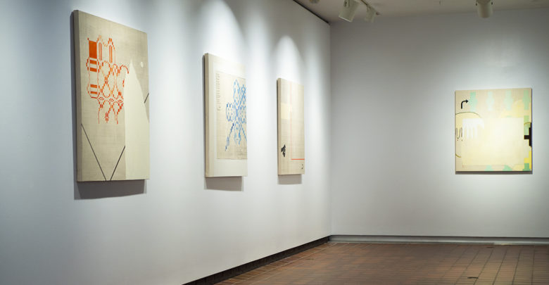 Kim McCollum paintings hanging in a gallery wall