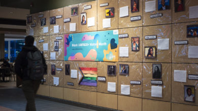 person walks by wall display