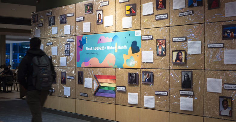 person walks by wall display