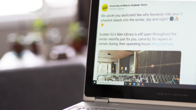 Laptop open on table with Twitter tweet