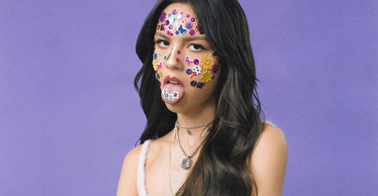 teenage girl with stickers on face sticking tongue out