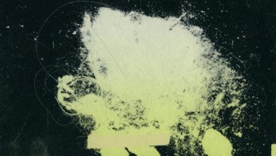 A photo of one of the displays in Andrew Testa's exhibit, over and over, again and again. It is green on a black background.