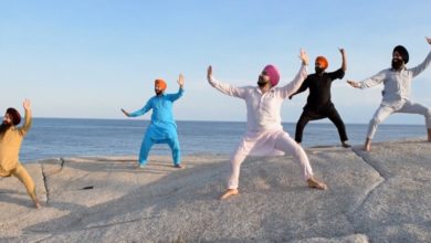 Five Indian Sikh men Bhangra dancing on rocks