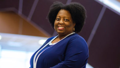 woman in blue sweater smiling at camera