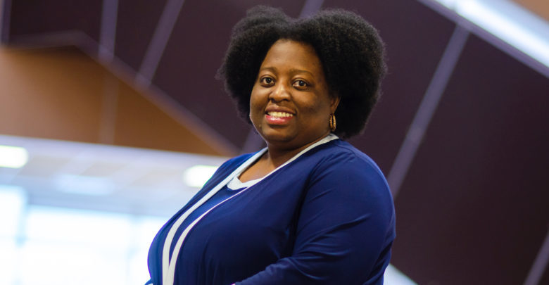 woman in blue sweater smiling at camera