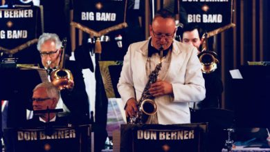 Don Berner stands up as he plays a saxophone part with the rest of the Don Berner and Big Band group.