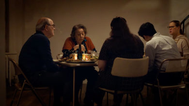 A scene from The Humans with cast members sitting at the dinner table.