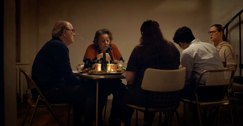 A scene from The Humans with cast members sitting at the dinner table.