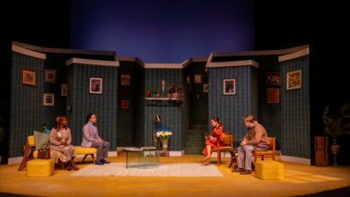 The set of God of Carnage, with both couples seated across from one another.