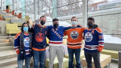 A photo of the five executive members of the NHL Analysts Club standing by the stairs in SUB.