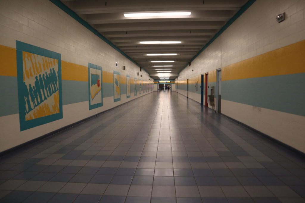 University LRT station hallway with art on the lefthand side