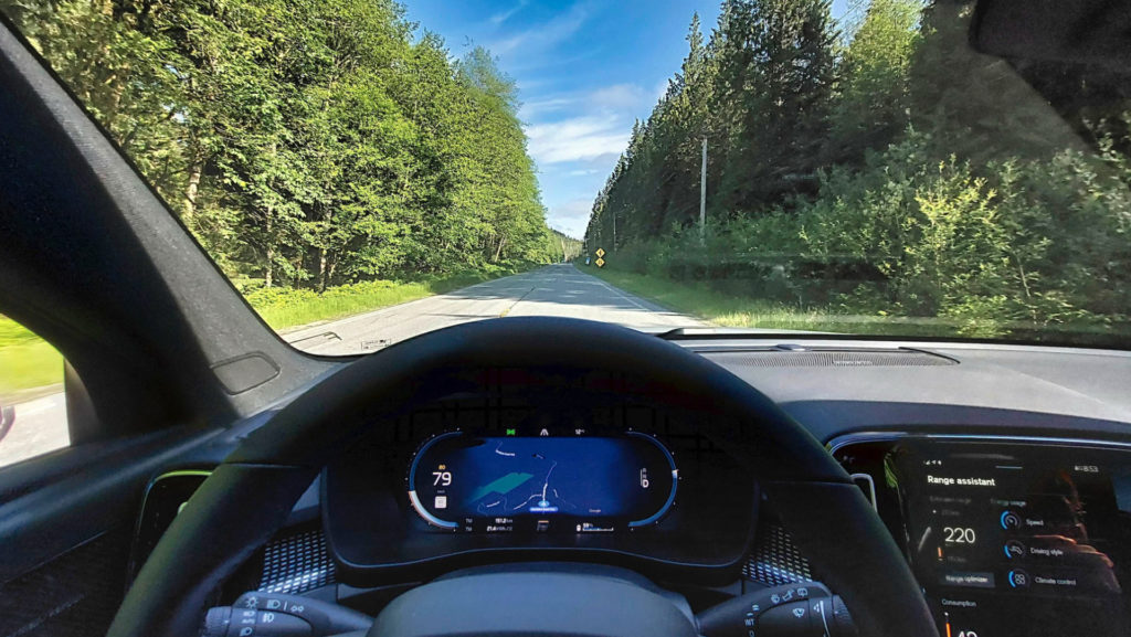 A view over a steering wheel driving north from Sechelt