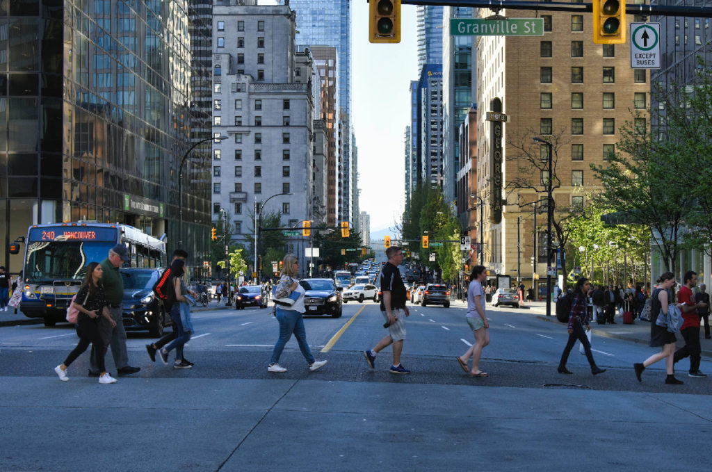 People walk on the crosswalk in Vancouver