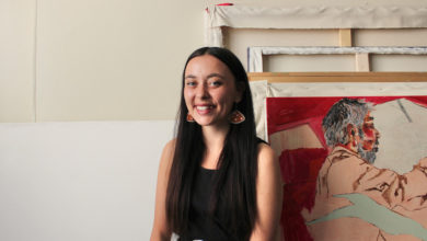 Kiona Callihoo Ligtvoet sits at a 45 degree angle wearing a black blouse smiling at the camera