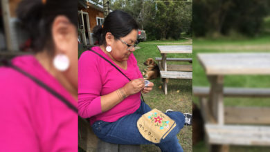 Tara Kappo sits in a pink blouse with her head turned away from the camera, beading in her lap