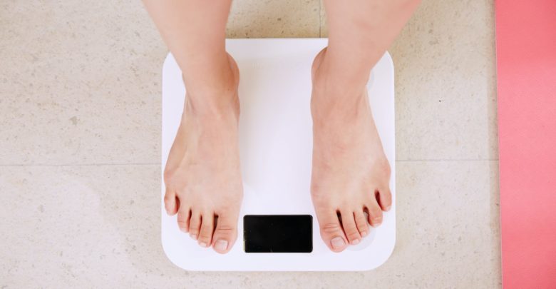 Photo by: I Yunmai, person standing on a weight scale