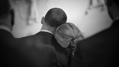 Photo by: vidar-nordli-mathisen, lady rests her head on man at funeral