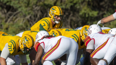 Title: Eli Hetlinger takes a snap against Calgary, Golden Bears preseason