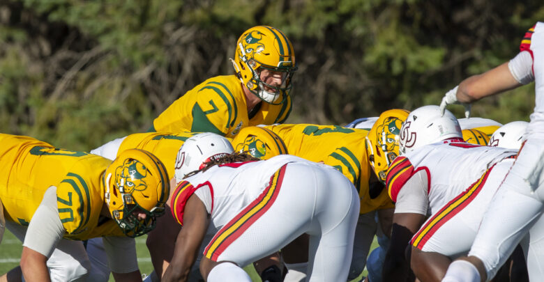 Title: Eli Hetlinger takes a snap against Calgary, Golden Bears preseason