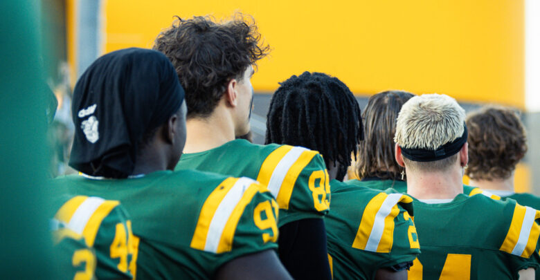 Golden Bears' sideline during the Canadian National Anthem at Foote Field